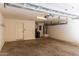 Spacious garage with overhead storage and a door, offering ample room for vehicles and storage solutions at 240 W Juniper Ave # 1146, Gilbert, AZ 85233