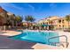 Community pool with sparkling blue water, lounge chairs, and beautiful condo views at 240 W Juniper Ave # 1146, Gilbert, AZ 85233