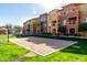 Community sand volleyball court surrounded by lush green grass for fun outdoor recreation at 240 W Juniper Ave # 1146, Gilbert, AZ 85233