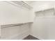 Walk-in closet with carpeted floor, white walls and white shelving at 240 W Juniper Ave # 1146, Gilbert, AZ 85233