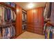 A well-organized walk-in closet featuring ample shelving and storage for clothing and accessories at 2612 N 161St Ave, Goodyear, AZ 85395