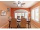 A formal dining room bathed in natural light, featuring an elegant table setting at 2612 N 161St Ave, Goodyear, AZ 85395