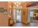 Inviting foyer with decorative console table, stylish door, and view into the home office at 2612 N 161St Ave, Goodyear, AZ 85395