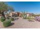 Well-maintained single-story home with desert landscaping, a tiled roof, and a welcoming entrance at 2612 N 161St Ave, Goodyear, AZ 85395