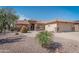 Charming home featuring a desert landscaped front yard, a tiled roof, and an attached two-car garage at 2612 N 161St Ave, Goodyear, AZ 85395