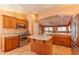 A spacious kitchen featuring wooden cabinetry, granite countertops, and stainless steel appliances at 2612 N 161St Ave, Goodyear, AZ 85395