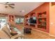 Inviting living room with built-in shelving, plush seating, wood-look floors and ample natural light at 2612 N 161St Ave, Goodyear, AZ 85395