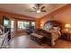 A serene main bedroom with a bay window, a sitting area and a ceiling fan at 2612 N 161St Ave, Goodyear, AZ 85395