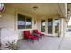 Covered patio seating area with matching red cushioned chairs with open view to the community greenspace at 2662 S Springwood S Blvd # 458, Mesa, AZ 85209