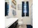 Well-lit bathroom with a modern vanity, decorative artwork, and stylish fixtures at 2849 W Apollo Rd, Phoenix, AZ 85041