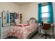 Cozy bedroom with colorful accents, a full-sized bed, and a practical study desk at 2849 W Apollo Rd, Phoenix, AZ 85041