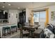 Bright dining area with a dining table, chairs, bench seating and connecting kitchen at 2849 W Apollo Rd, Phoenix, AZ 85041