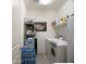 Spacious laundry room featuring modern washer and dryer, plus ample storage shelving at 2849 W Apollo Rd, Phoenix, AZ 85041