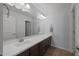 A bright, modern bathroom features a long vanity with under cabinet storage and a large mirror with vanity lights at 2923 E Preston St, Mesa, AZ 85213