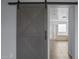 A view of the bathroom through the gray wood-style barn door at 2923 E Preston St, Mesa, AZ 85213