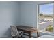 A cozy bedroom with a desk nook and a serene view offers a quiet space for work or relaxation at 2923 E Preston St, Mesa, AZ 85213