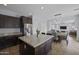 Spacious kitchen and dining area with dark wood cabinetry, granite counters, and stainless-steel appliances at 2923 E Preston St, Mesa, AZ 85213