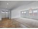 Spacious living area with neutral paint, chandelier and tile flooring transitioning into carpet at 2923 E Preston St, Mesa, AZ 85213