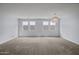 Neutral living room showcasing carpeted floors, a chandelier, and bright, natural light at 2923 E Preston St, Mesa, AZ 85213