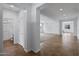 Open-concept living space with a chandelier, neutral paint, and tiled flooring leading to carpeted area at 2923 E Preston St, Mesa, AZ 85213