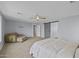 Serene main bedroom featuring a ceiling fan, calming paint color, and a barn door leading to the bathroom at 2923 E Preston St, Mesa, AZ 85213