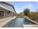 Backyard pool has a water feature, travertine decking and manicured plants at 2923 E Preston St, Mesa, AZ 85213