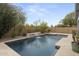 Backyard pool with water feature is surrounded by lush greenery at 2923 E Preston St, Mesa, AZ 85213