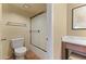 Well-lit bathroom featuring a toilet, shower with frosted doors, vanity, and a framed inspirational print at 3031 N Civic Center Plz # 339, Scottsdale, AZ 85251