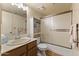 Well-lit bathroom with a vanity and an adjacent toilet with a shower and frosted glass doors at 3031 N Civic Center Plz # 339, Scottsdale, AZ 85251