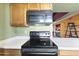 Kitchen featuring an electric range with white countertops and wood cabinets at 3031 N Civic Center Plz # 339, Scottsdale, AZ 85251