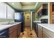 View of kitchen with wood cabinets, tile floor, and modern black appliances at 3031 N Civic Center Plz # 339, Scottsdale, AZ 85251