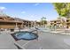 Outdoor pool area featuring a hot tub, lounge chairs, and mature landscaping at 3031 N Civic Center Plz # 339, Scottsdale, AZ 85251