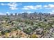 Stunning aerial view showcasing the neighborhood's charming homes and the city skyline in the background under a bright blue sky at 348 W Portland St, Phoenix, AZ 85003