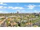 Aerial shot showcasing the city skyline, lush palm trees, and quiet residential neighborhood with well maintained homes at 348 W Portland St, Phoenix, AZ 85003