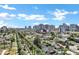 Beautiful aerial view of the homes lining a street with palm trees against a city backdrop under a clear blue sky at 348 W Portland St, Phoenix, AZ 85003