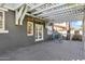 Covered back patio features a pergola, wooden deck, bicycle and surfboard, offering a perfect outdoor living space at 348 W Portland St, Phoenix, AZ 85003