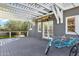 Spacious covered back patio featuring a pergola, wooden deck, bicycle, and surfboard for outdoor enjoyment at 348 W Portland St, Phoenix, AZ 85003