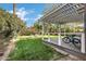 Expansive backyard featuring a well-manicured lawn, pergola, and a charming fire pit area, perfect for outdoor relaxation at 348 W Portland St, Phoenix, AZ 85003