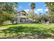 Large backyard featuring mature trees, green lawn, and a covered back porch at 348 W Portland St, Phoenix, AZ 85003