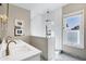 Bright bathroom featuring a glass enclosed shower, double vanity, and marble floors at 348 W Portland St, Phoenix, AZ 85003