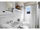 Classic bathroom featuring white subway tiles, vintage sink, updated fixtures, and bright natural light at 348 W Portland St, Phoenix, AZ 85003