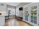 Bright breakfast nook with hardwood floors, a bench and bright doors to the yard at 348 W Portland St, Phoenix, AZ 85003