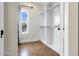 Organized walk-in closet with custom shelving and a sunlit window at 348 W Portland St, Phoenix, AZ 85003