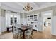 Elegant dining room with natural light, stylish chandelier, and an adjacent built-in china cabinet at 348 W Portland St, Phoenix, AZ 85003