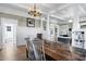 Lovely dining room featuring classic wainscotting, a rustic dining table, and an open view to other spaces at 348 W Portland St, Phoenix, AZ 85003