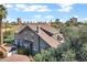 An elevated view shows the house with a brown roof and a gray wall with some downtown buildings in the distance at 348 W Portland St, Phoenix, AZ 85003