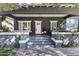 Inviting front porch with a swing, stylish decor, a hanging lantern, and lush plants, creating a relaxing outdoor space at 348 W Portland St, Phoenix, AZ 85003