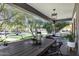 Inviting front porch with an outdoor dining area, a swing, and elegant decor, providing a comfortable and stylish outdoor living space at 348 W Portland St, Phoenix, AZ 85003