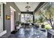 Relaxing front porch with a dining set, stylish lighting, and verdant plants, offering a perfect spot for outdoor dining and relaxation at 348 W Portland St, Phoenix, AZ 85003