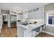 Elegant kitchen with marble countertops, stainless steel appliances, island seating and custom white cabinetry at 348 W Portland St, Phoenix, AZ 85003